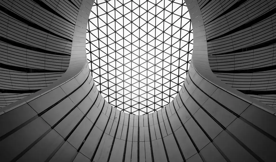 Black-and-white geometric ceiling at Beijing Daxing International Airport with a gridded skylight at the center.