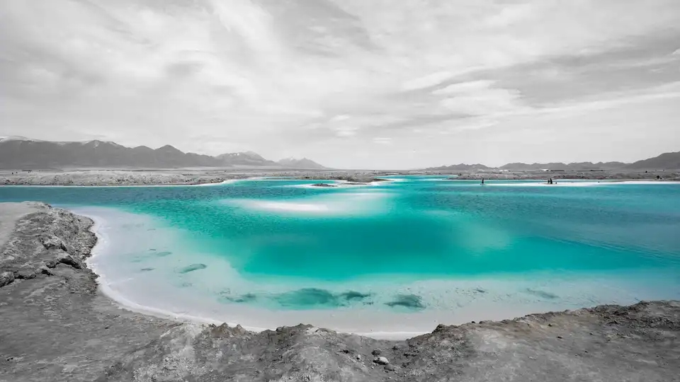 Blue-green salt lake water at Dachaidan Emerald Lake, surrounded by pale shorelines.